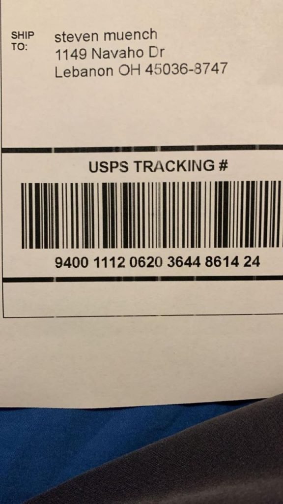 USPS shipping label on a delivered parcel showing tracking number 9400 1112 0620 3644 8614 24